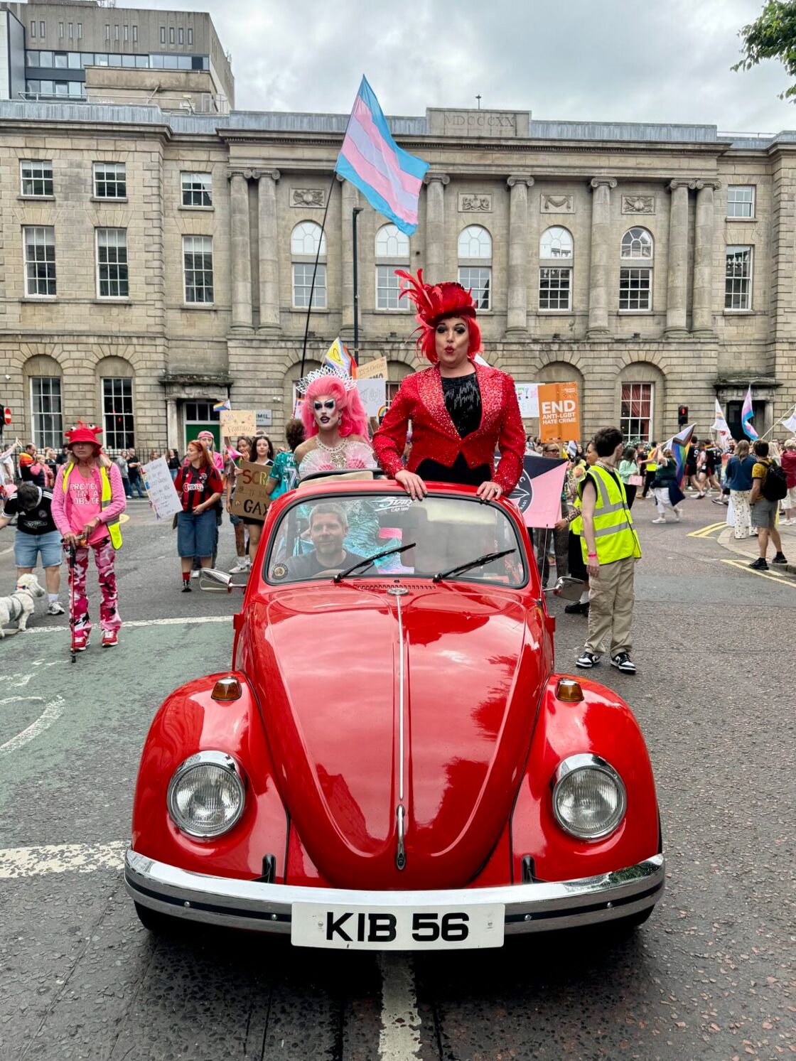Drag queens on a red beetle