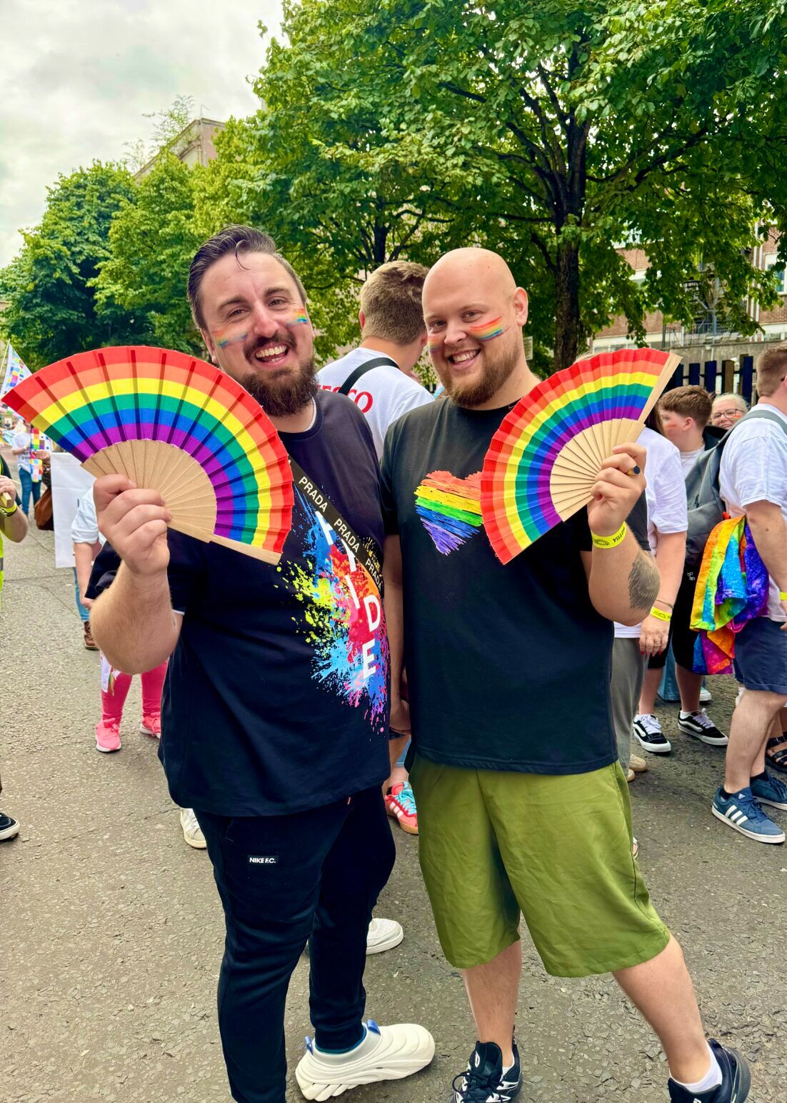 gay couple with pride fans in Belfast