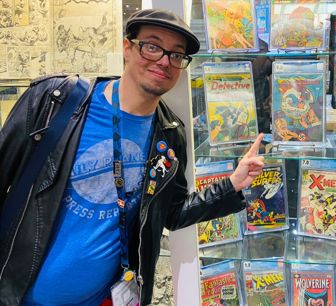 Julian Jetson posing with an image of Superman fighting Nazis