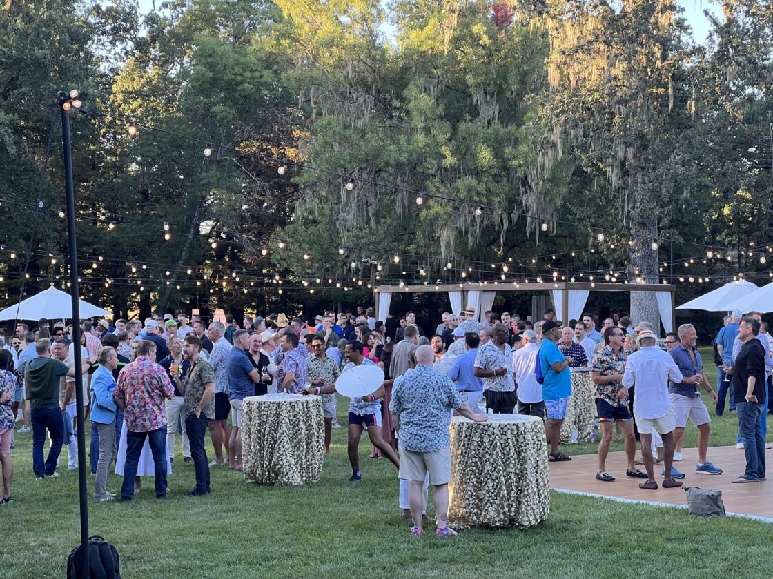 The Gay Wine Weekend welcome reception, featuring string lights around a scenic vineyard.