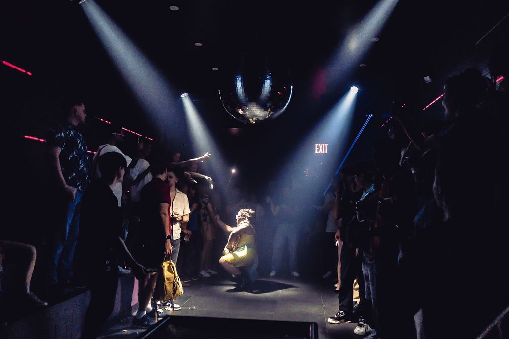 A drag queen performs in the middle of a crowded dance floor at The Ritz Bar & Lounge.