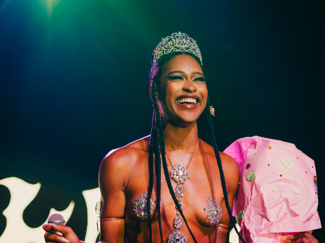 A drag queen smiles wearing a crown after winning a title at Bushwig.