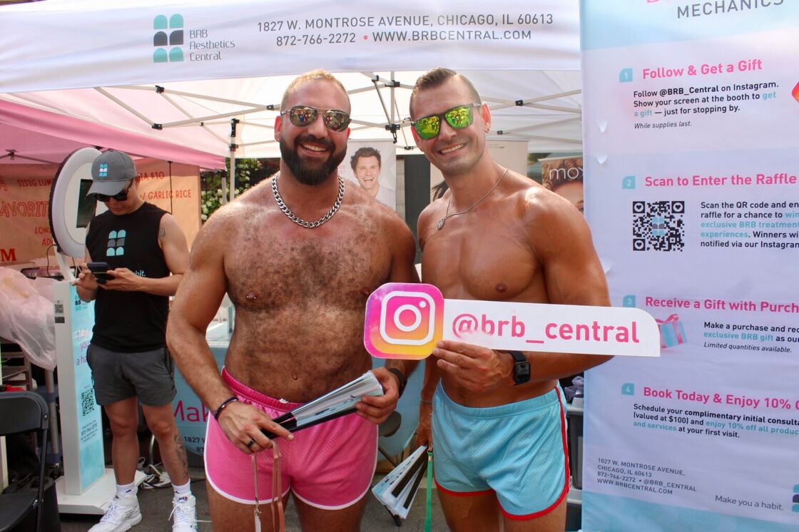Two shirtless men smile and pose in front of BRB Central's vendor booth at Chicago Market Days.