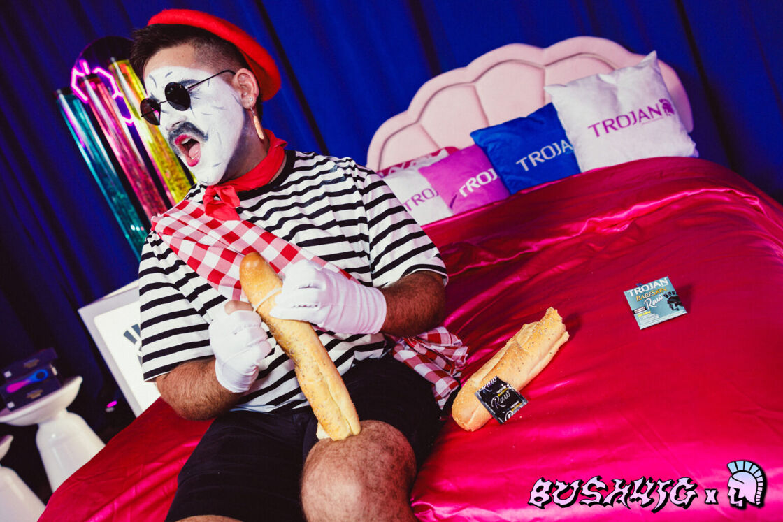 A mime puts a condom on a baguette at Bushwig.