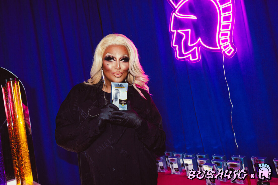 Roxxxy Andrews poses with a Trojan background at Bushwig.