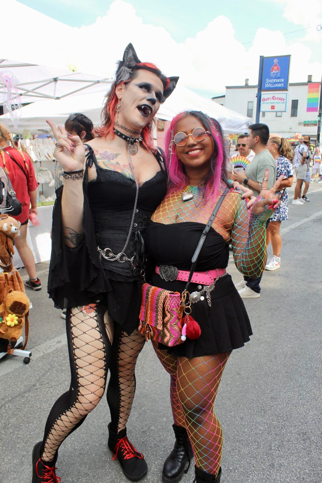 Two festivalgoers throw up peace signs at Chicago's Market Days.