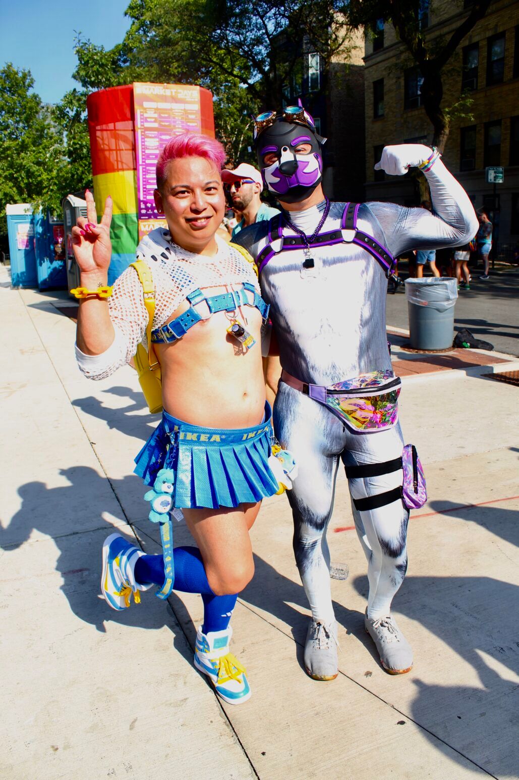 A man wearing an IKEA bag skirt and a pup smile and pose at Chicago's Market Days.