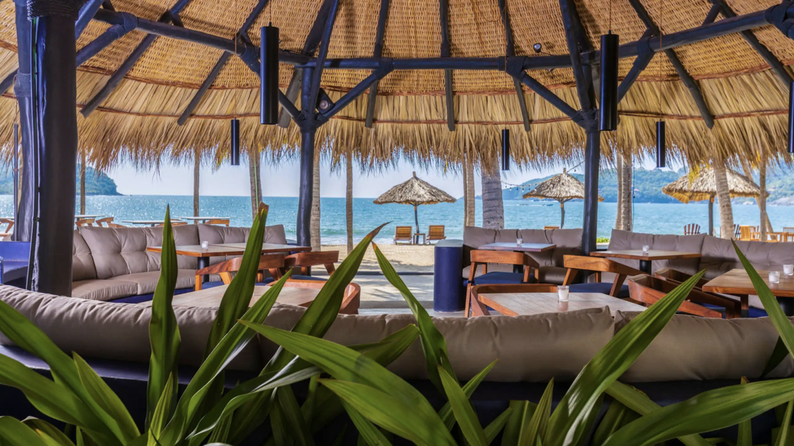Scenic beach views under a palapa at Thompson Zihuatanejo