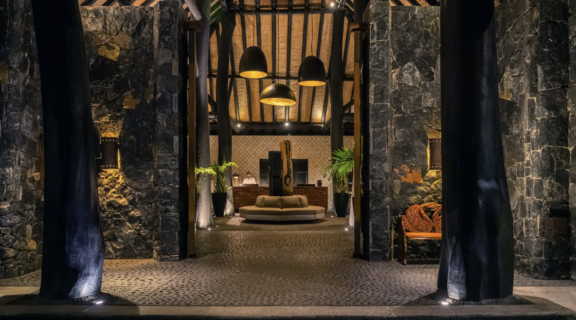The lobby of Thompson Zihuatanejo, decorated in rocks and sophisticated lighting, is pictured at night.