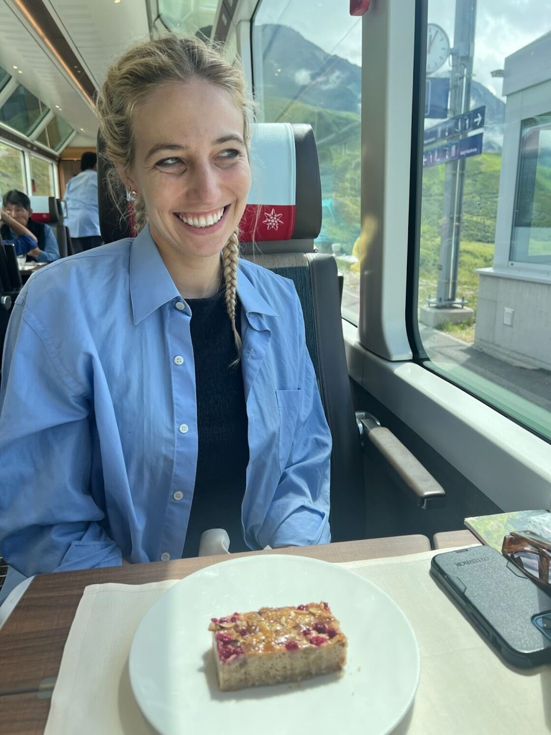 Alexia Garcia smiles while eating aboard Switzerland's Glacier Express.