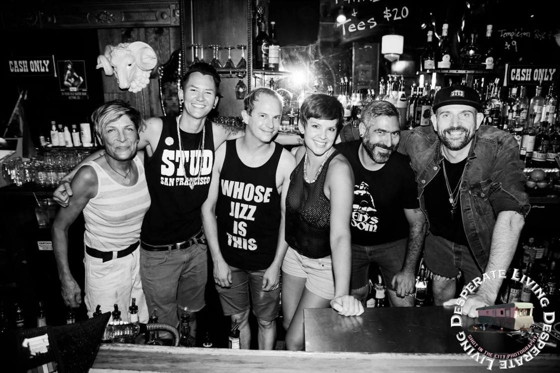 Rachel Ryan and The Stud staff members pose behind the bar in a black and white photo.