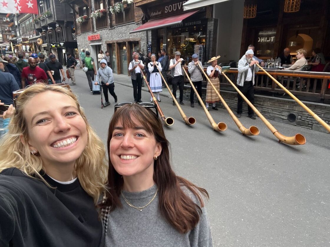 Switzerland locals in Zermatt play alphorns while Alexia Garcia and her girlfriend watch on.  