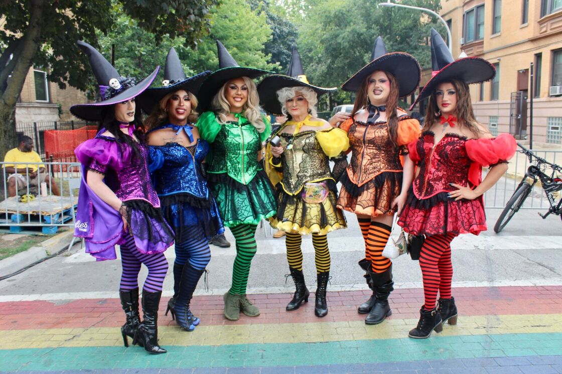A group of drag queens dressed as rainbow colored witches pose at Chicago's Market Days.
