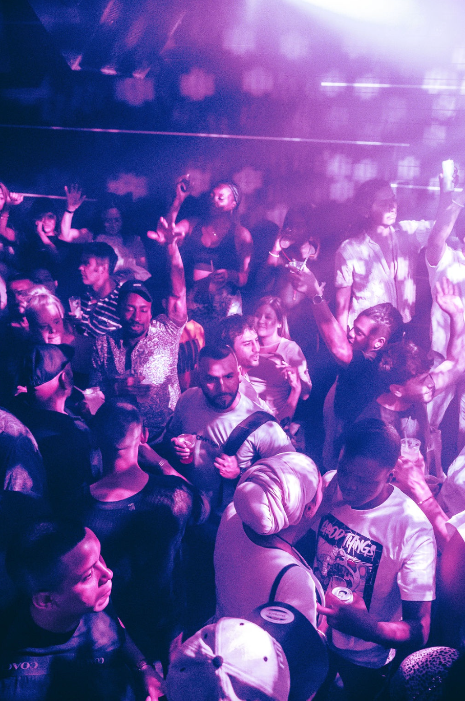 A crowded dance floor of men kissing and dancing at The Ritz Bar & Lounge.
