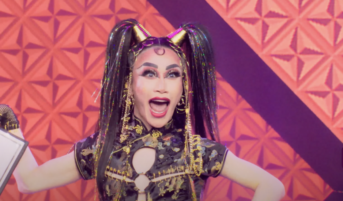 A drag queen performs with two black ponytails and a black dress on the stage in a trailer from "Drag Race Philippines: Slaysian Royale."