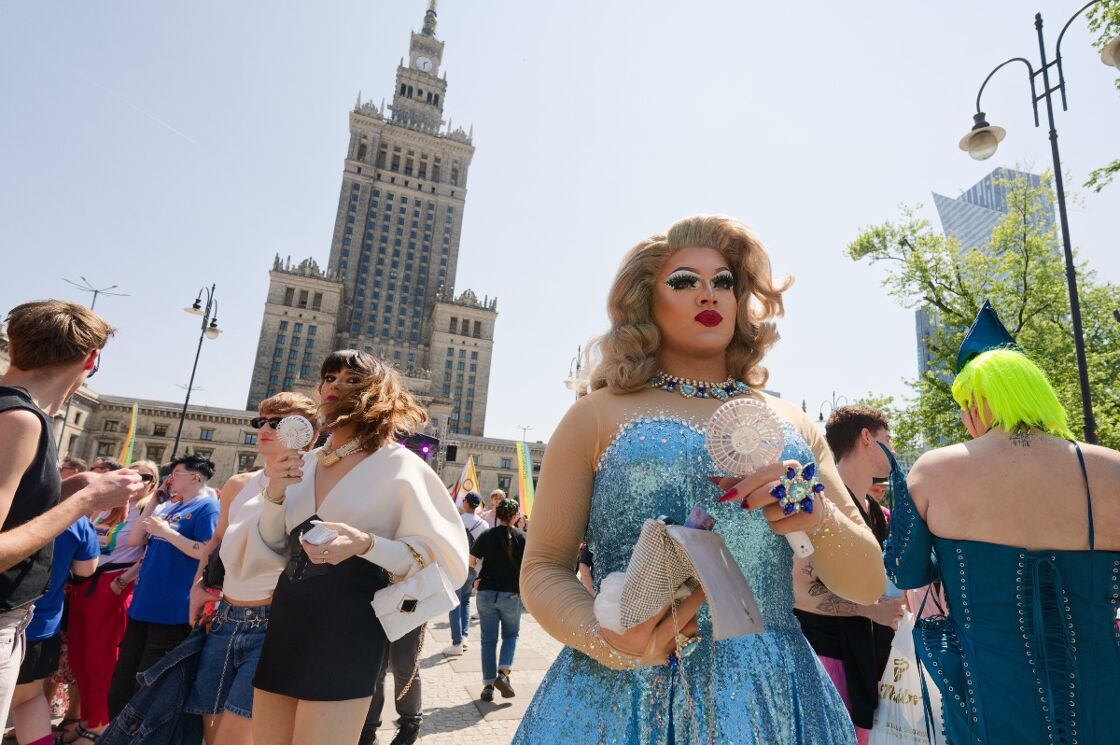 A drag queen stands in front of the Palace of Culture in Warsaw, Poland