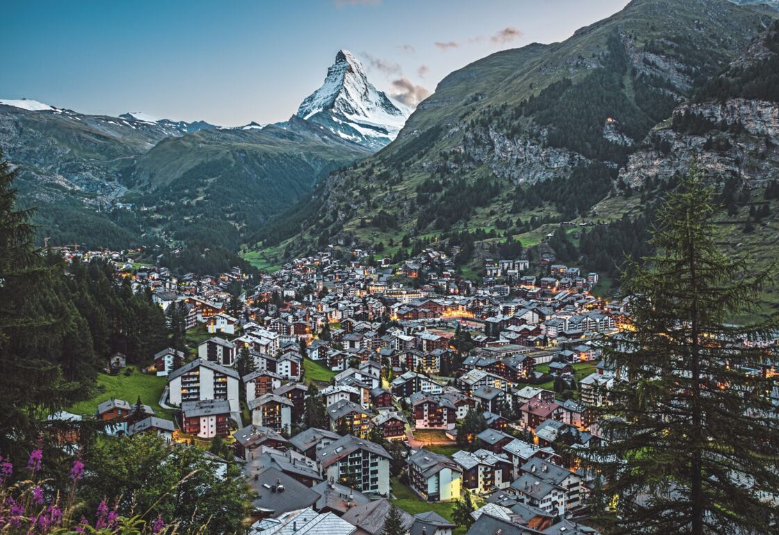 The Matterhorn mountain and the car-free resort of Zermatt pictured at its foot during the daytime.