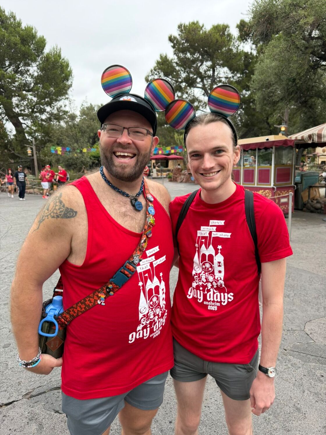 Two men smile in rainbow Mickey ears at Disneyland's Anaheim Gay Days.