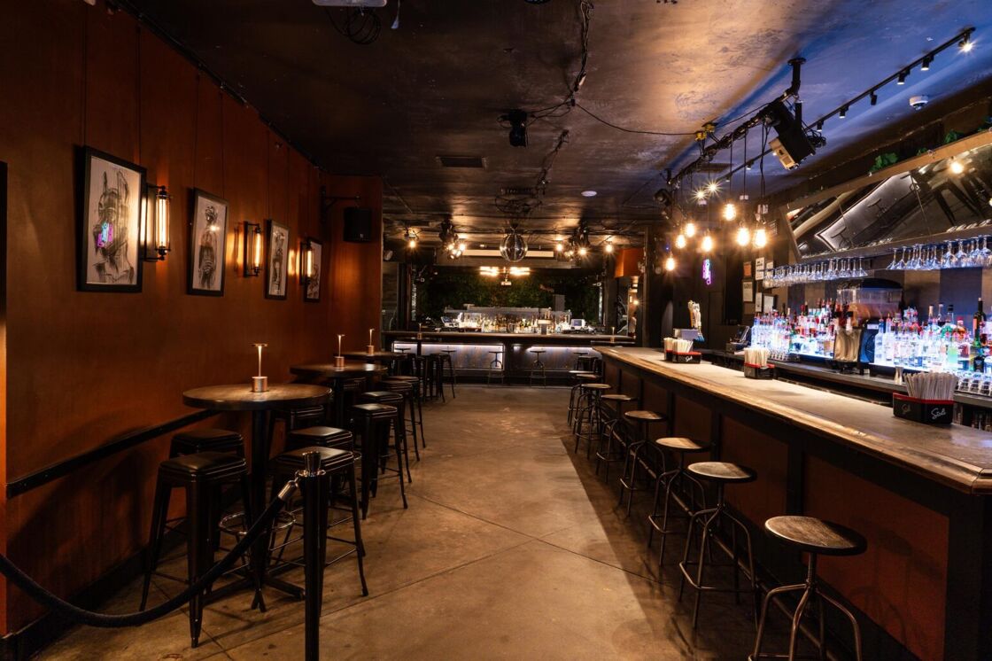 A hall at gay bar G Lounge, showing off seating on the left and a bar on the right.