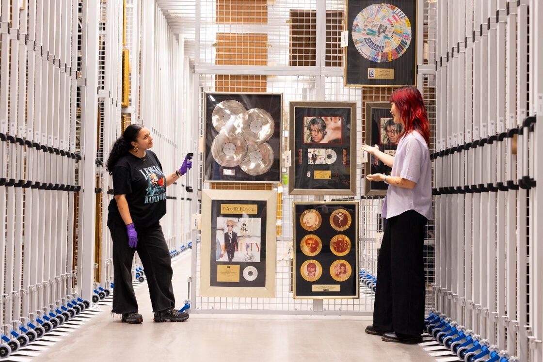 A visitor sees some of David Bowie’s awards in
storage, at their Order an Object appointment
at V&A East Storehouse.