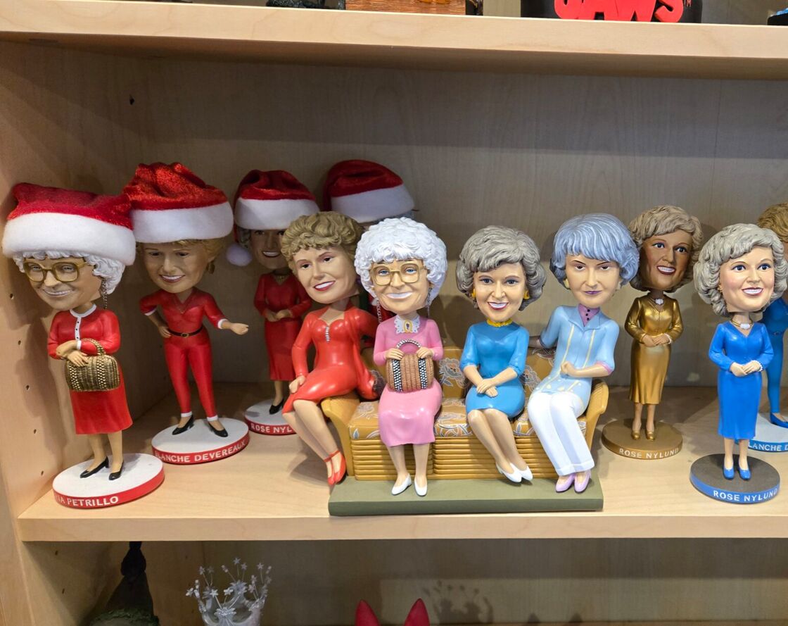 A shelf of different Golden Girls-themed bobbleheads on display at the National Bobblehead Hall of Fame and Museum.