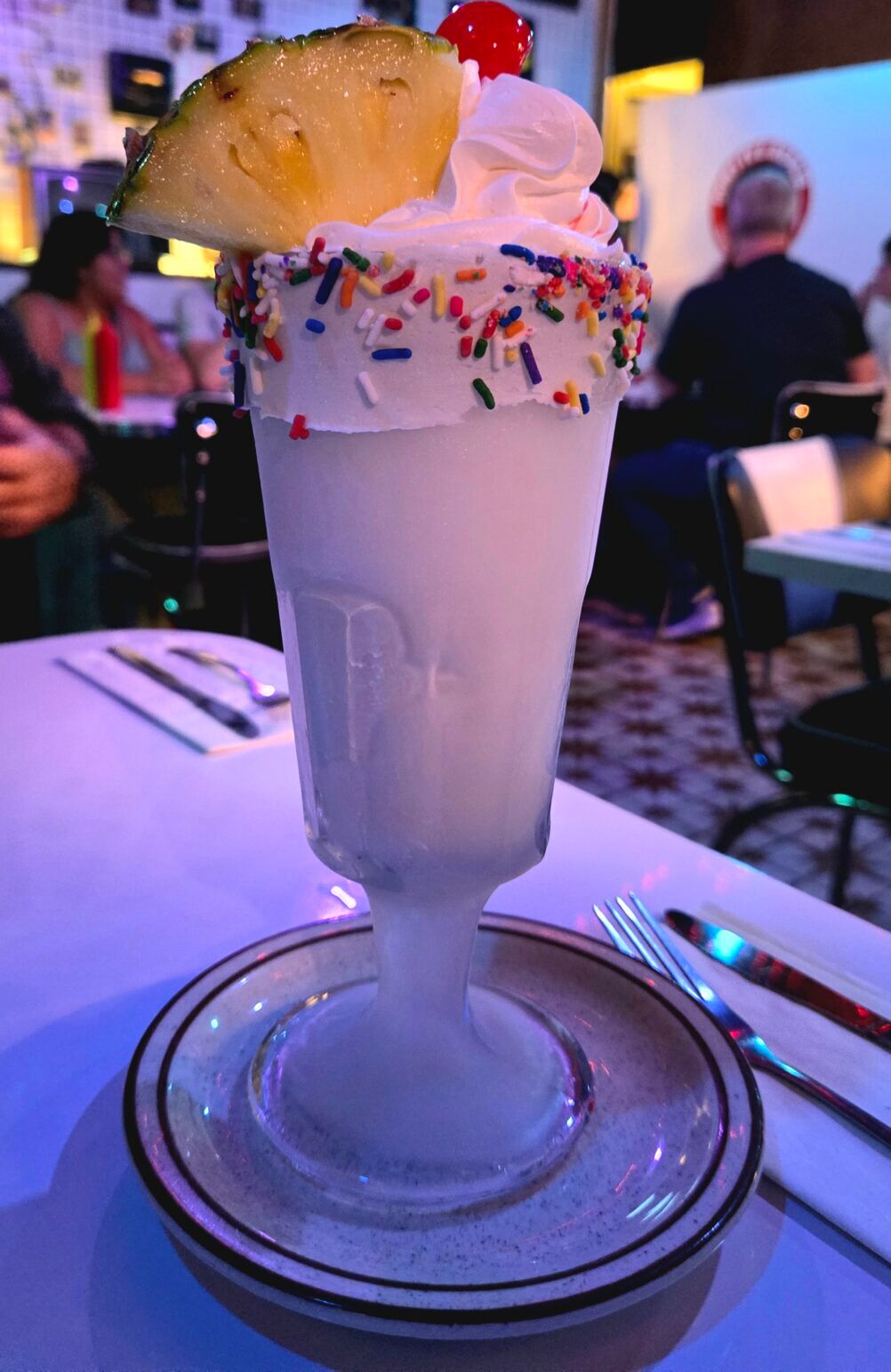 A boozy milkshake topped with whipped cream and a pineapple slice at Don's TV & Repair Shop.