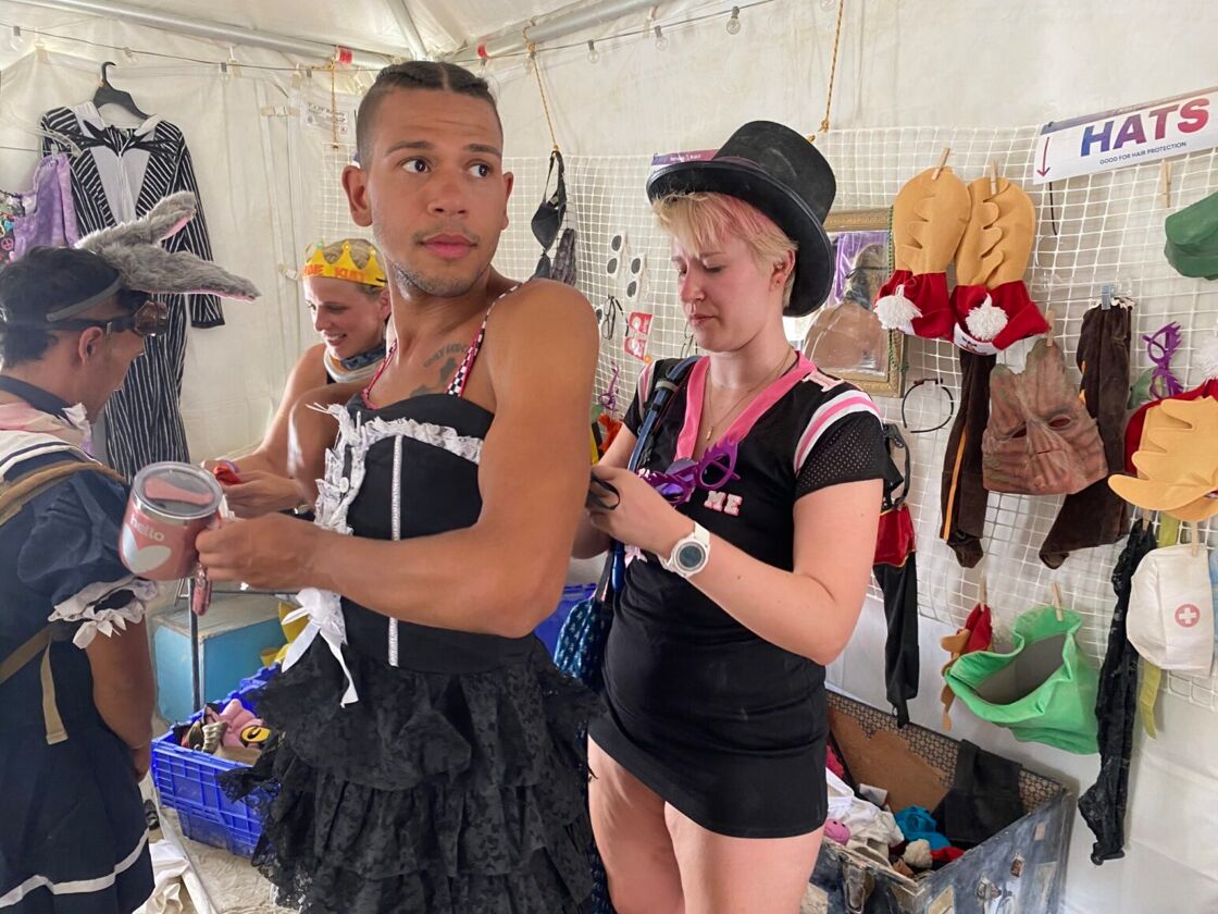 Queer pop star Kameron trying on a gender bending Burning Man ensemble.