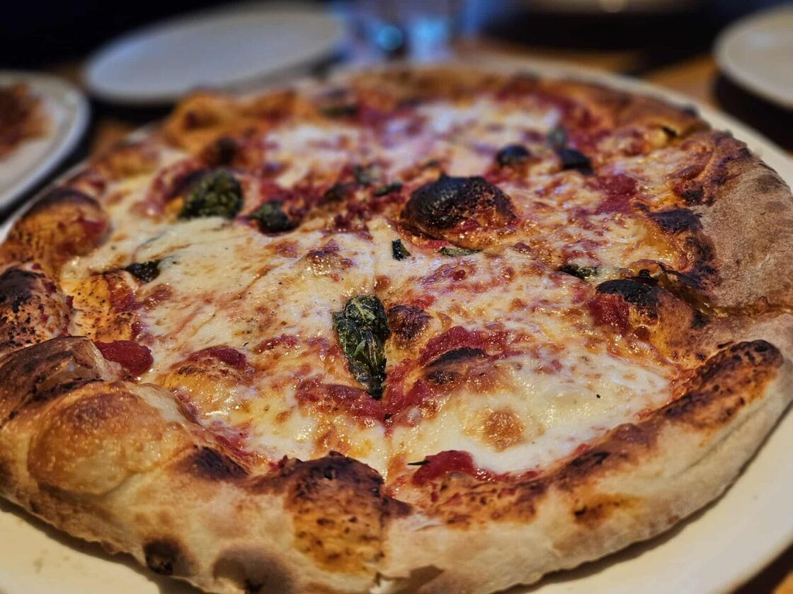 An appetizing personal pizza plated at Tre Rivali in Milwaukee.