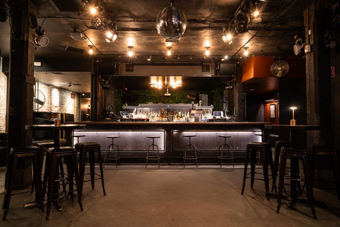 The central bar at G Lounge, pictured behind a disco ball and with seating to the left and right.