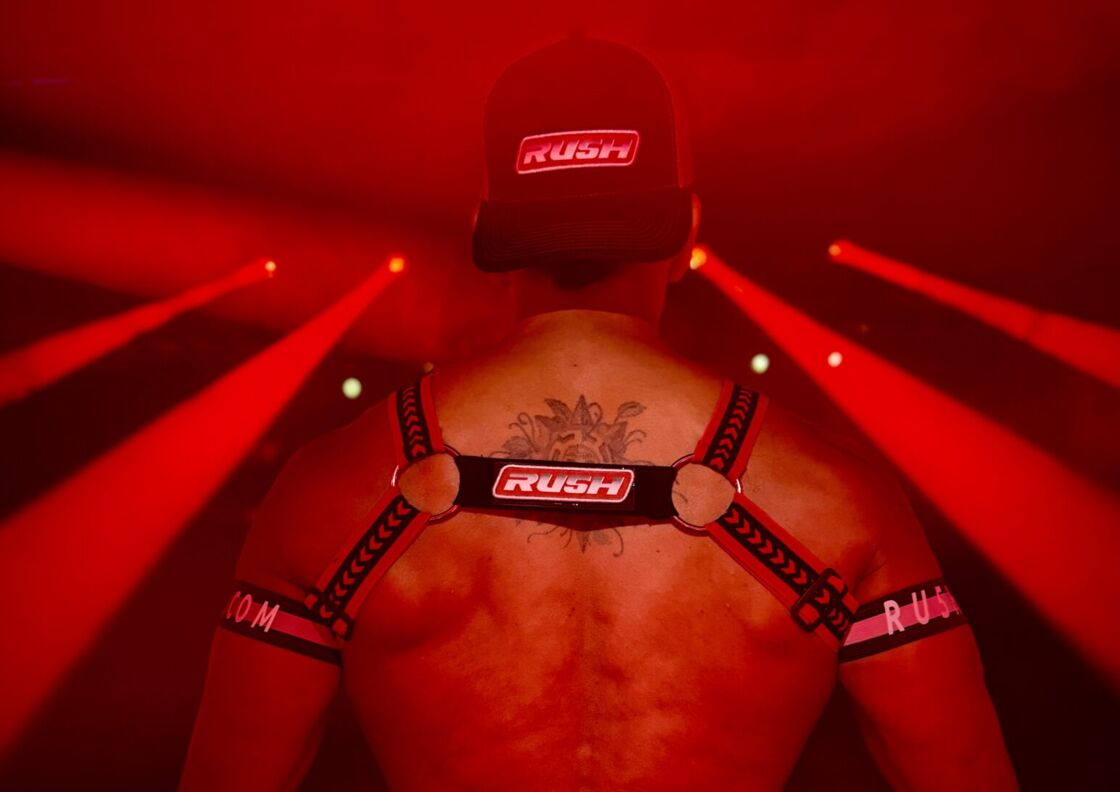 A man in a 'RU5H' harness