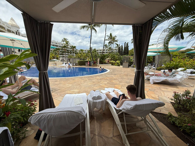 The outdoor pool at the Fairmont Kea Lani pictured from underneath a poolside cabana.