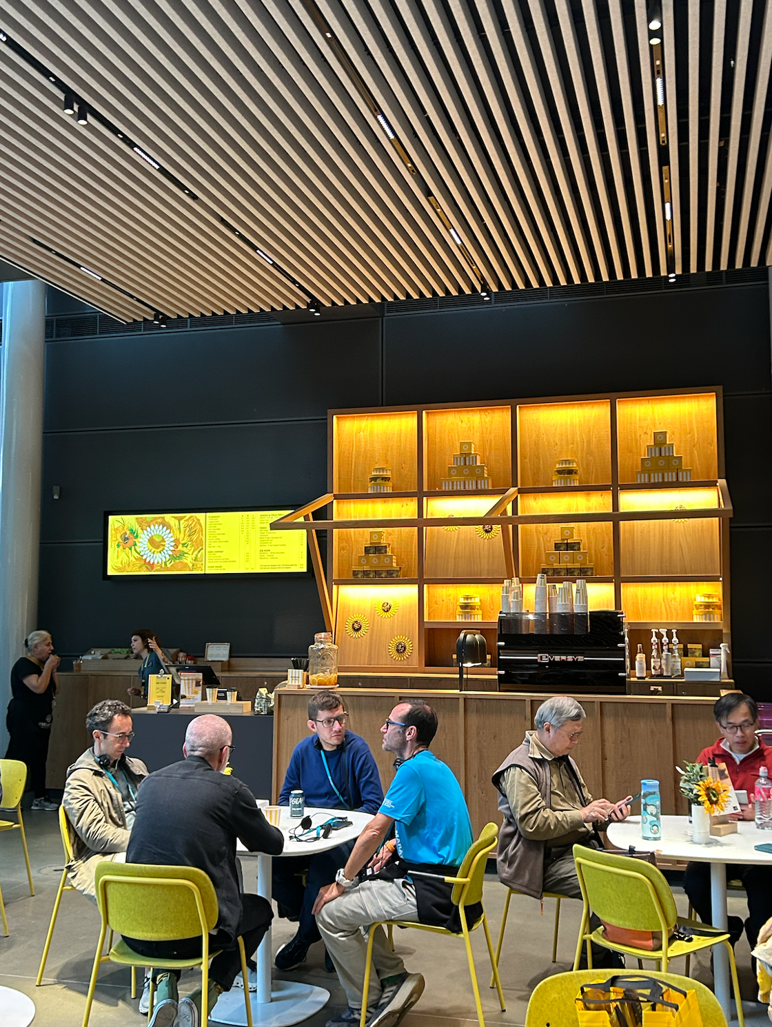 Patrons sit and chat at the sunflower-themed cafe at the Van Gogh Museum.