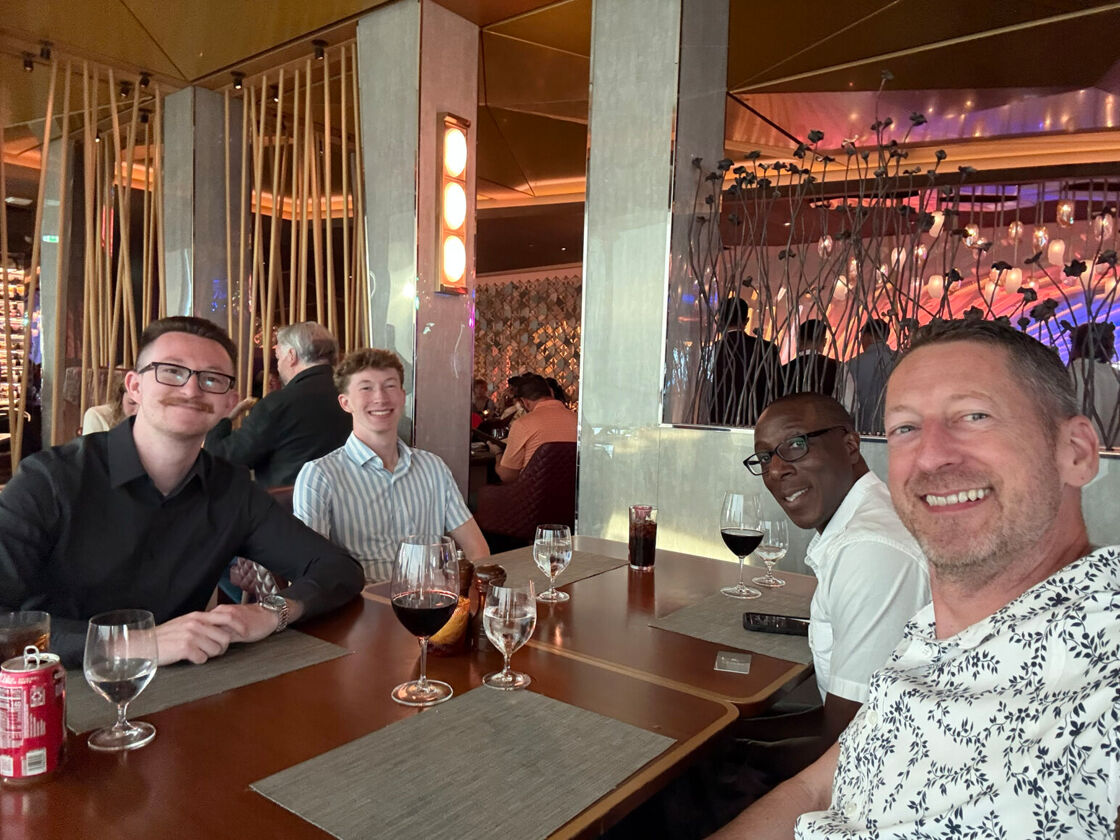 The author (right), his sons, and husband (second from left) enjoy a meal aboard their Alaskan cruise.
