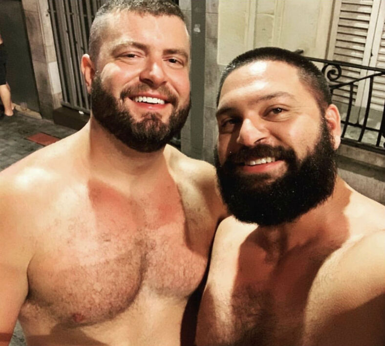 two men with beards and topless smiling 