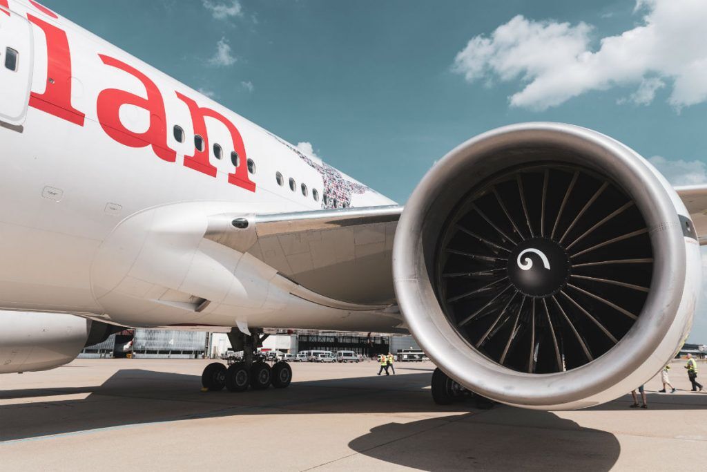 View of an airplane on the tarmac with a focus on the engine