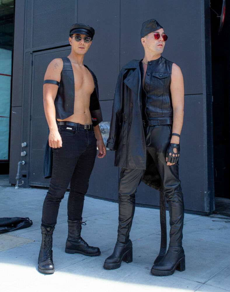 Two people dressed in sleek leather outfits.