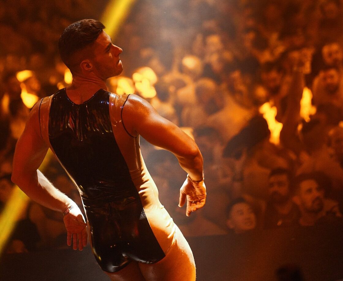 A man dances in front a crowd