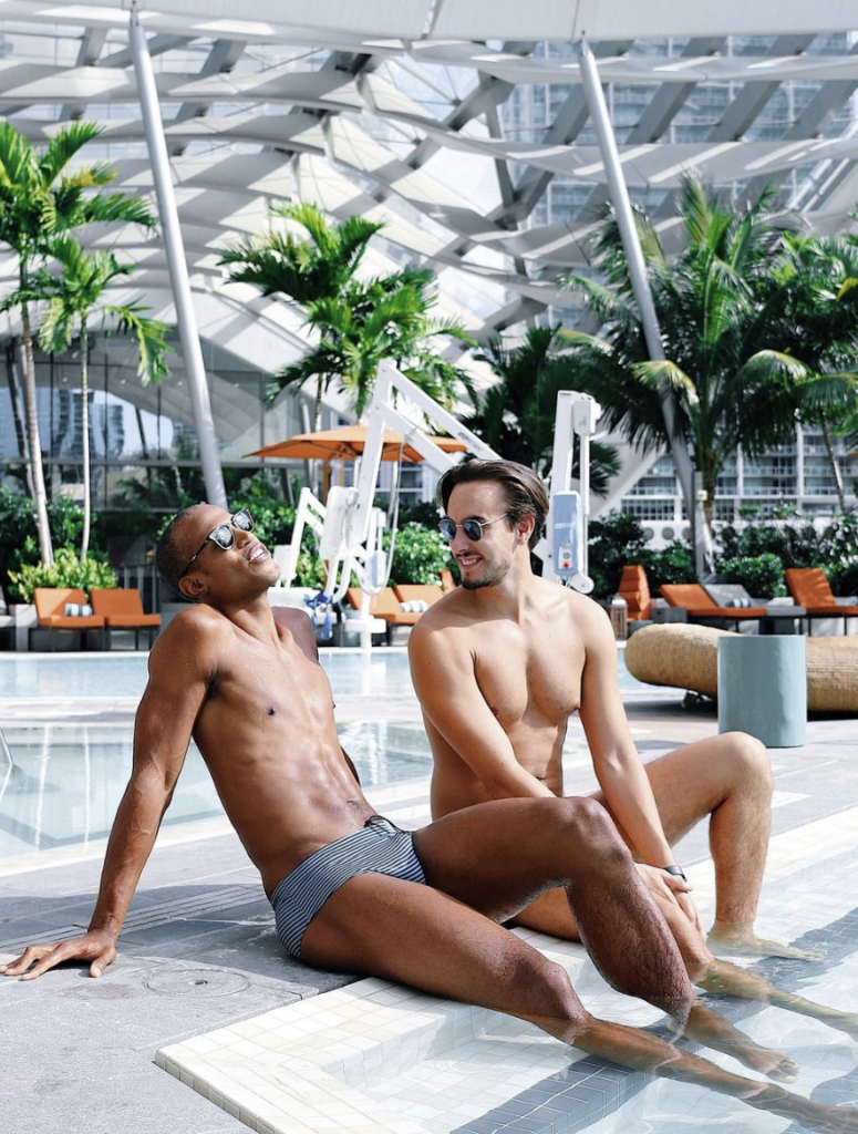 Two men lounge near the EAST Miami pool
