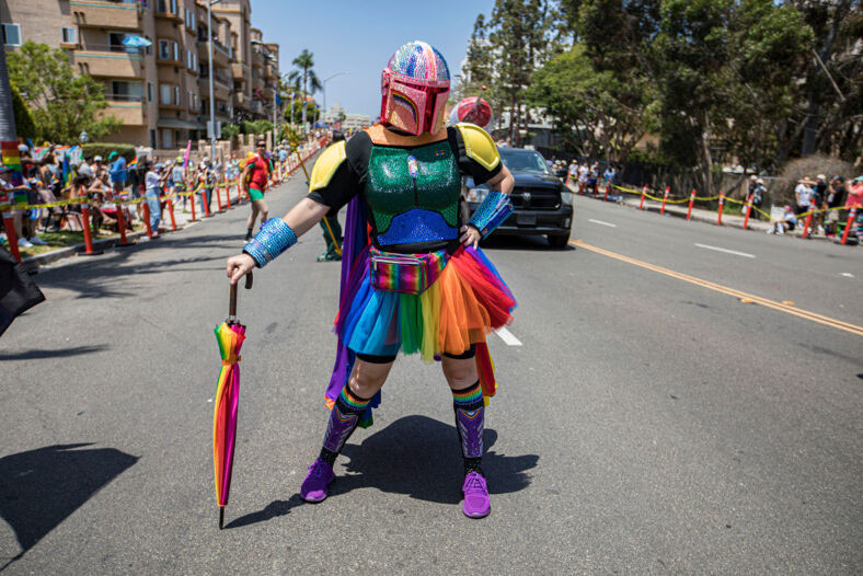 A rainbow sequined storm trouper strikes a pose on the parade route