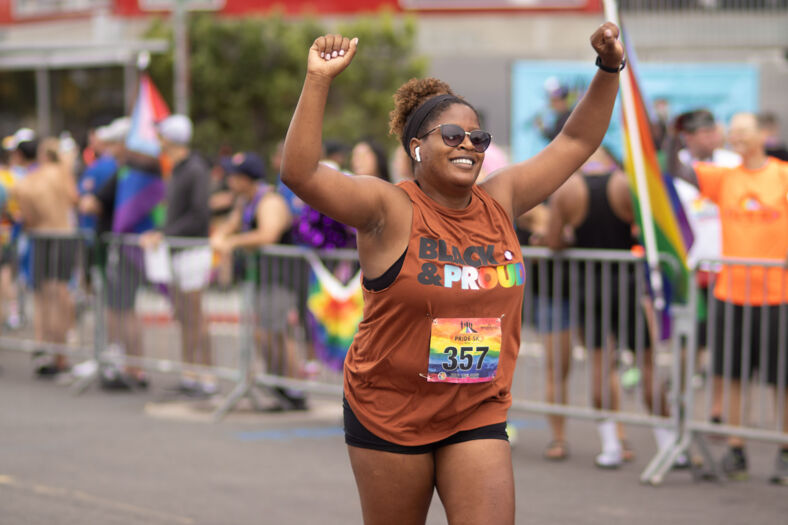 A woman finishing the Pride 5K