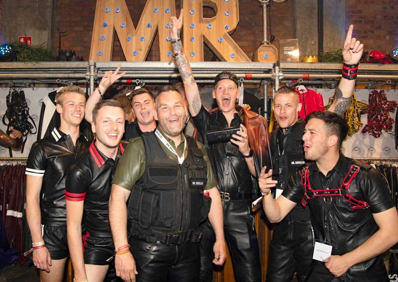 A group of men in fetish outfits posing for the camera at Darklands.