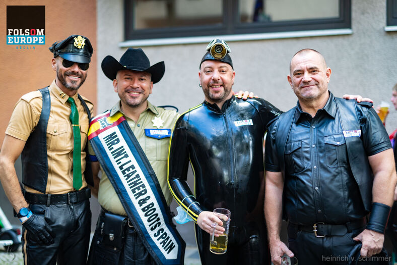 Four men in fetish outfits posing for the camera.