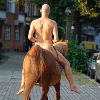 Nude man on horseback.