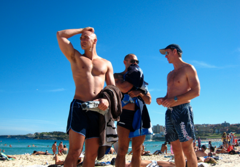 shirtless men on the beach