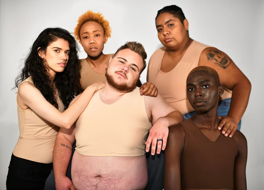 A group of people wearing chest binders