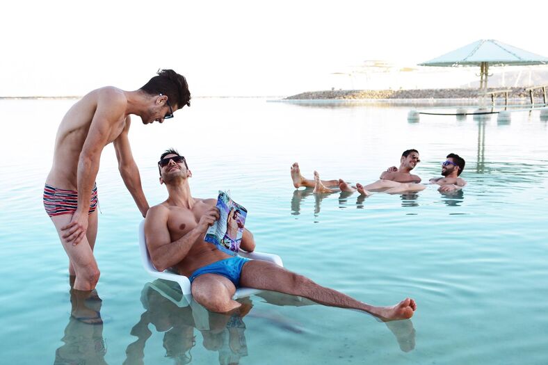 Two gay couples relaxing in the pool.